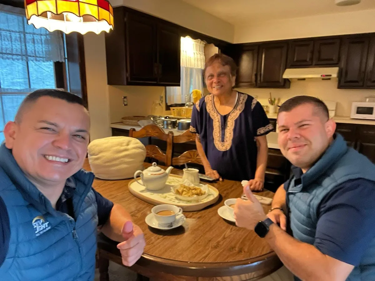 Two Skylight Roofing team members at a homeowner's kitchen table after a roof inspection