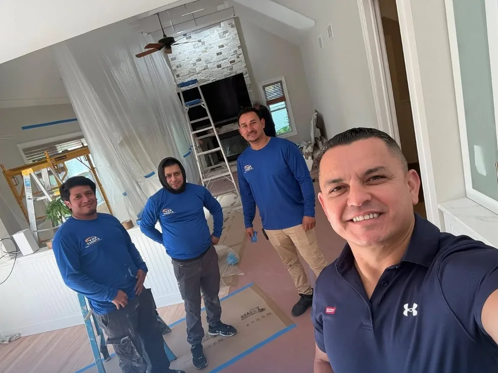 Skylight Roofing crew inside a home with plastic sheeting hung and the floors papered before work starts
