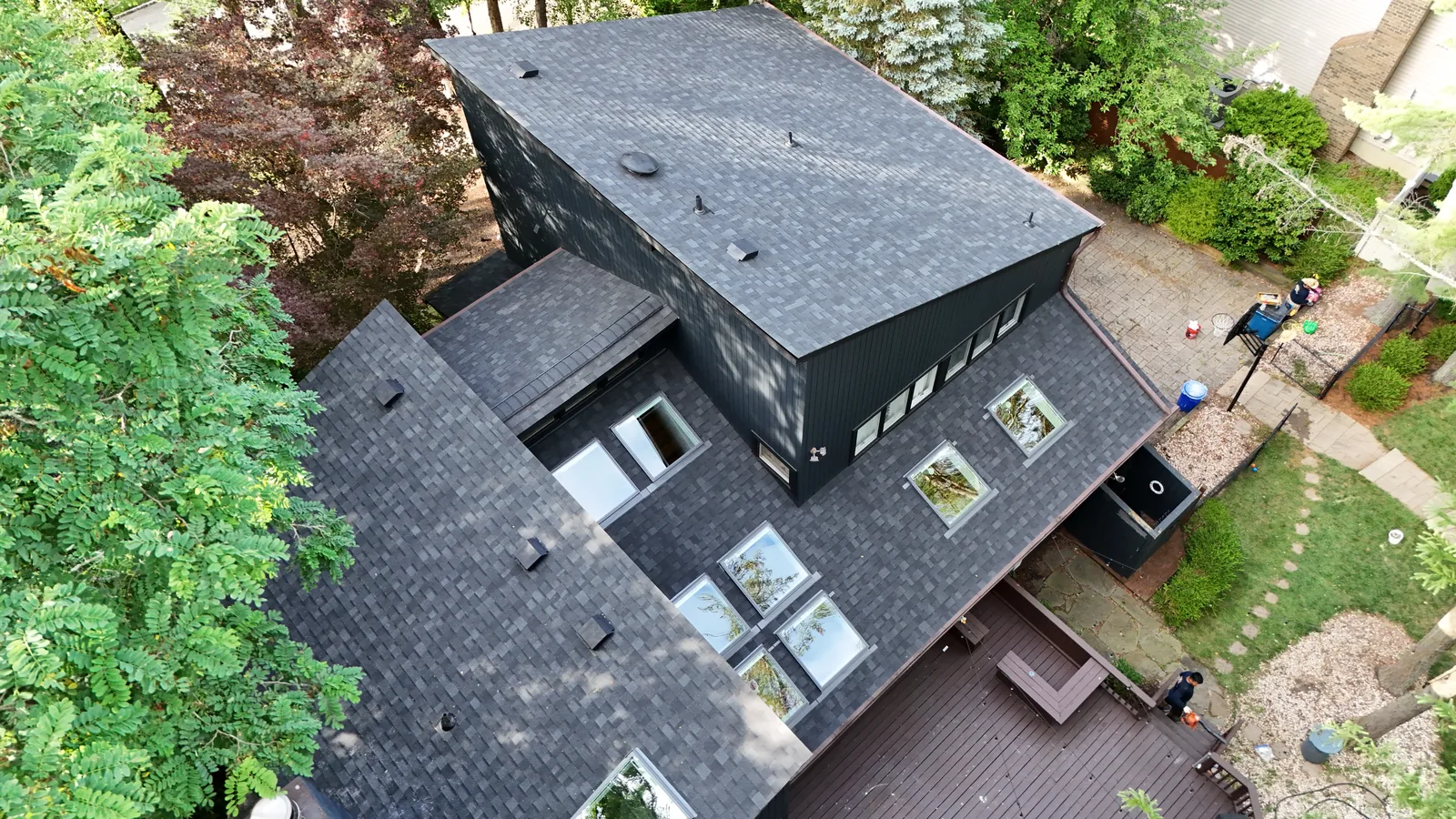 Aerial view of the completed roof replacement in Marlboro, NJ, Onyx Black shingles on a dark sided contemporary home