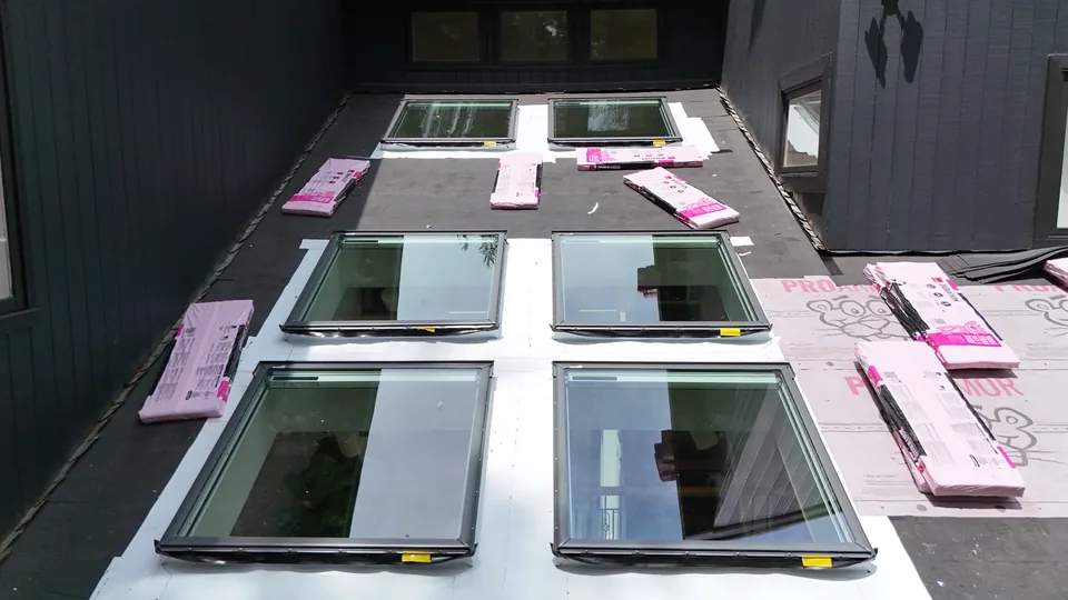 New VELUX skylight units staged on the roof before installation in Marlboro, NJ