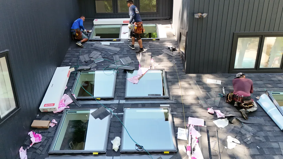 Roofing crew setting the VELUX skylight units into the roof in Marlboro, NJ