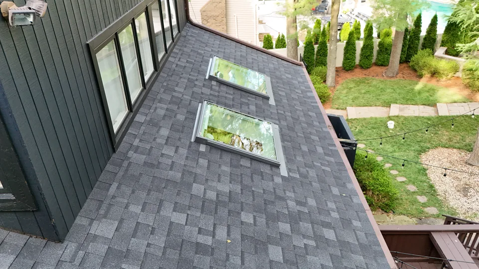 Completed Marlboro, NJ roof with two VELUX skylights, seen from above the rear garden